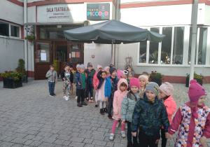 Dzieci stoją przed teatrem Piccolo